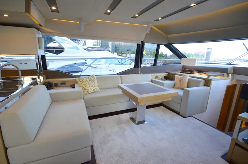 Slide: The Image of Interior of a 2017 Prestige 630 yacht with elegant seating area and large windows. - 28