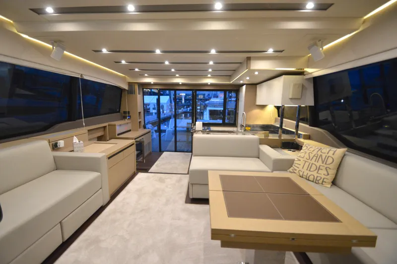 Slide: The Image of The image shows the luxurious interior of a 2017 Prestige 630 yacht with elegant furnishings and lighting. - 39