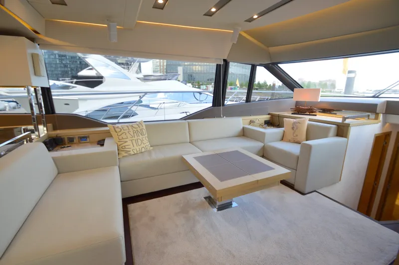Slide: The Image of Luxurious salon of a 2017 Prestige 630 yacht with elegant white sofas and large windows. - 30