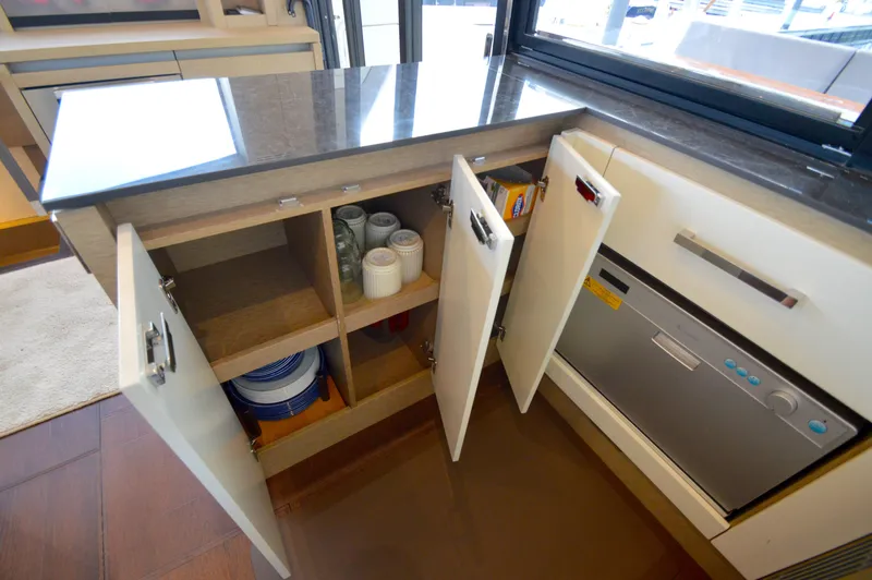 Slide: The Image of The galley of a 2017 Prestige 630 yacht with cabinets and a dishwasher. - 20