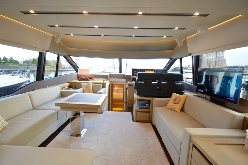 Slide: The Image of Luxurious salon of a 2017 Prestige 630 yacht with elegant sofas and a TV. - 11