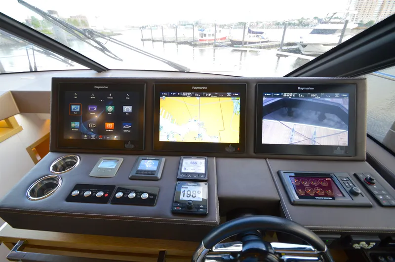 Slide: The Image of The image shows the helm of a 2017 Prestige 630 yacht with multiple screens and controls. - 37