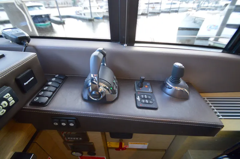 Slide: The Image of The image shows the helm of a 2017 Prestige 630 yacht with modern controls. - 38