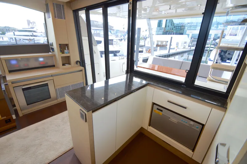 Slide: The Image of The galley of a 2017 Prestige 630 yacht with modern appliances and large windows. - 16