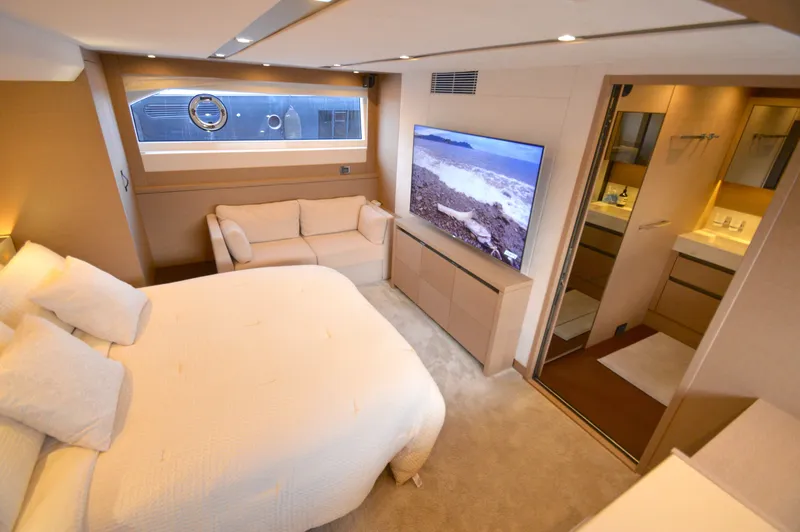 Slide: The Image of Luxurious bedroom with large bed, sofa, flat-screen TV, and en-suite bathroom. - 48