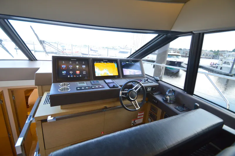 Slide: The Image of Interior view of a 2017 Prestige 630 yacht helm with modern navigation systems. - 35