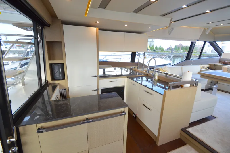 Slide: The Image of The galley of a 2017 Prestige 630 yacht with modern appliances and sleek design. - 13