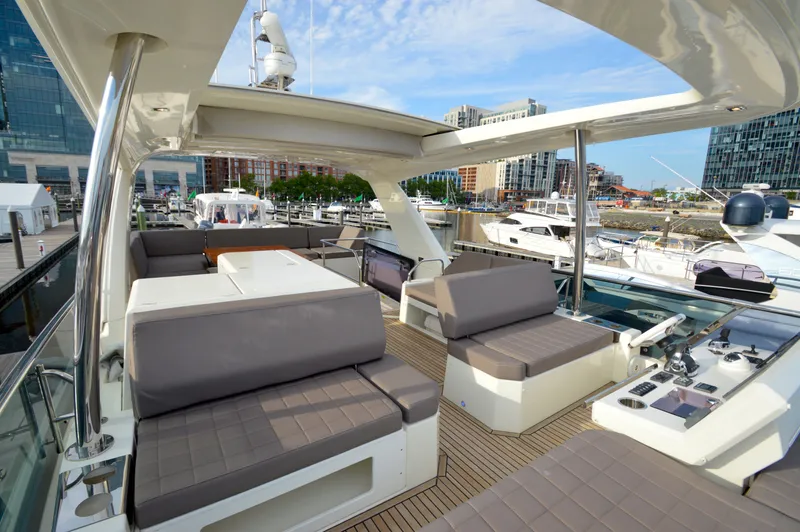 Slide: The Image of The 2017 Prestige 630 features a spacious deck with gray cushions and modern controls. - 4