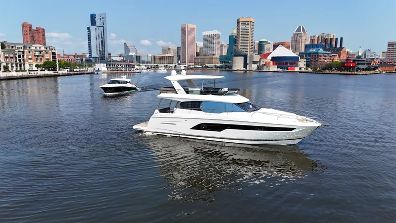 Slide: The Image of A luxurious white yacht cruises through an urban harbor with skyscrapers in the background. - 7