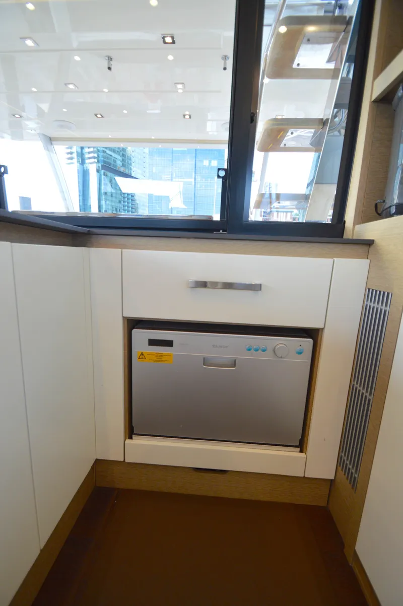 Slide: The Image of The galley of a 2017 Prestige 630 yacht featuring a built-in dishwasher. - 17