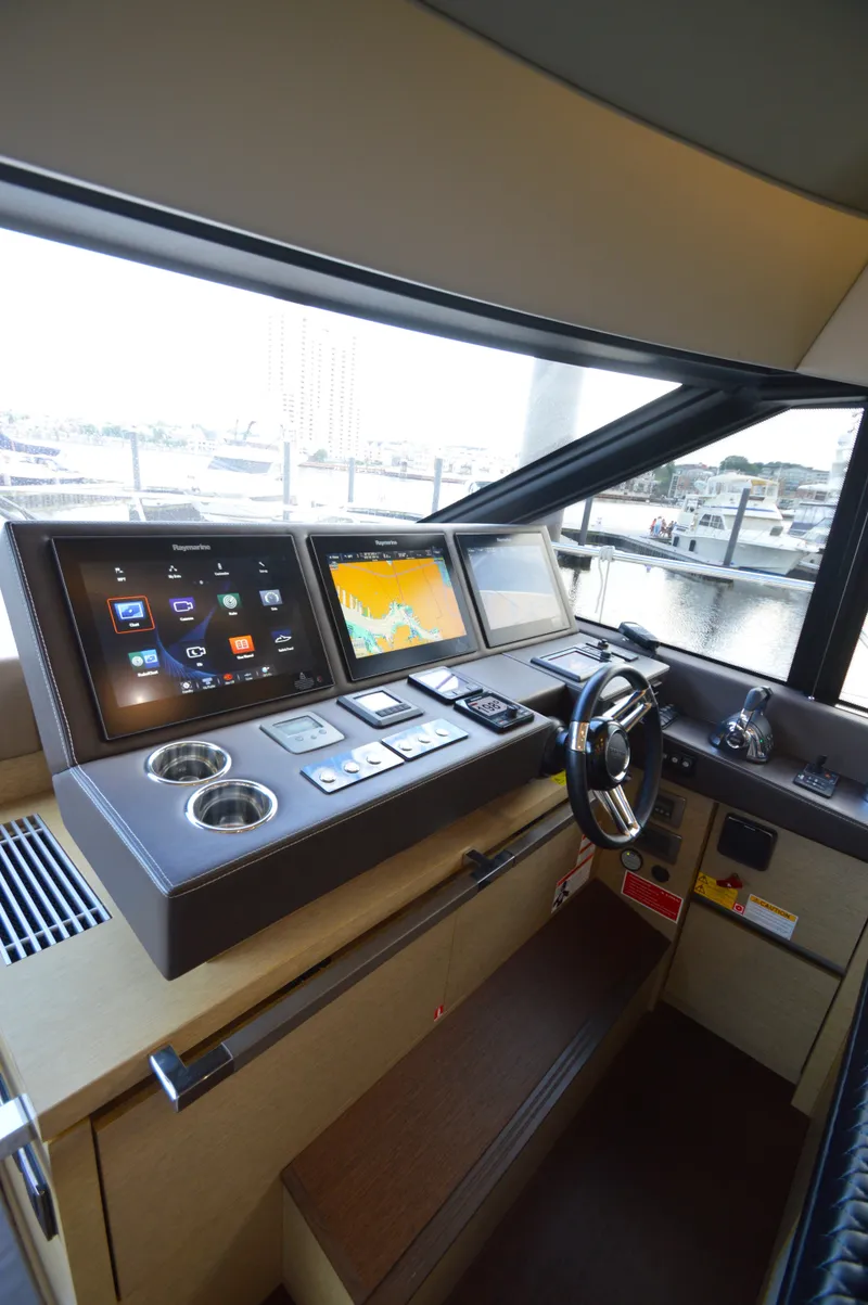 Slide: The Image of The cockpit of the 2017 Prestige 630 features modern navigation systems and a sleek steering wheel. - 36