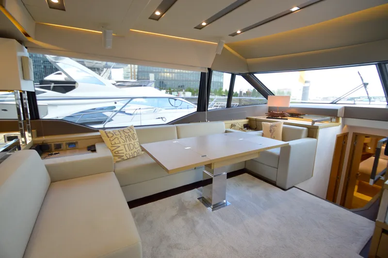 Slide: The Image of Interior of a 2017 Prestige 630 yacht with elegant seating area and large table. - 32
