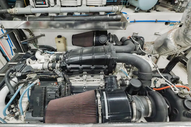 Slide: The Image of Engine room of a 2016 Hargrave Flybridge Motor Yacht, showcasing complex machinery and components. - 84