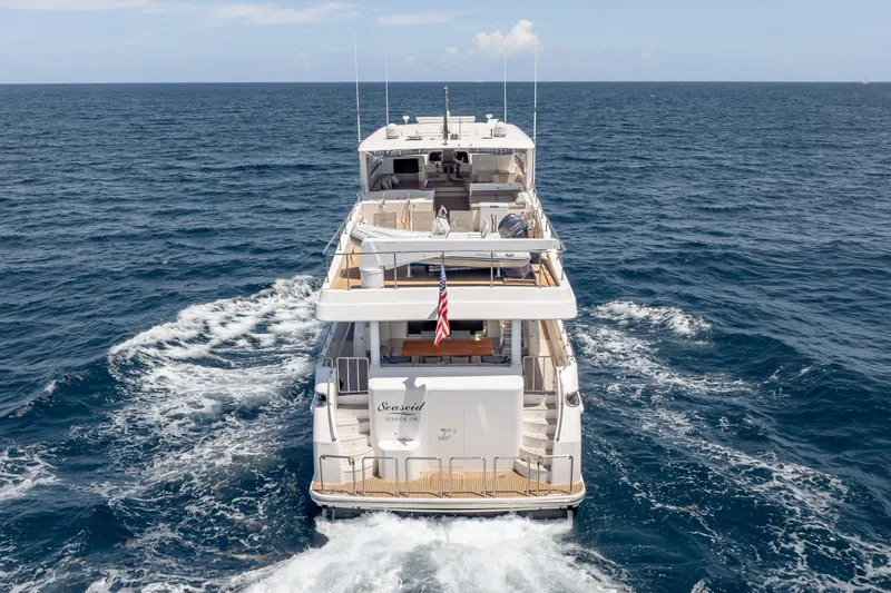 Slide: The Image of 2016 Hargrave Flybridge Motor Yacht cruising on open sea, rear view. - 93
