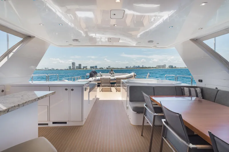 Slide: The Image of Luxurious 2016 Hargrave Flybridge Motor Yacht interior with ocean view and elegant seating area. - 64