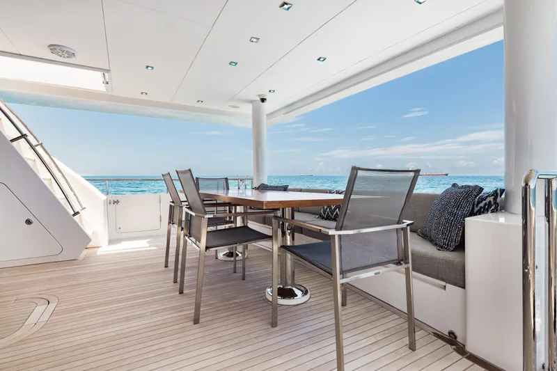 Slide: The Image of Luxurious 2016 Hargrave Flybridge Motor Yacht deck with ocean view and elegant seating. - 50
