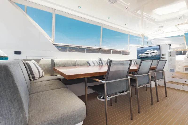 Slide: The Image of Luxurious 2016 Hargrave Flybridge Motor Yacht interior with elegant dining area and panoramic windows. - 63