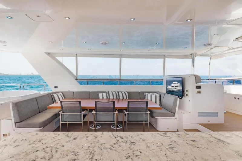 Slide: The Image of Luxurious 2016 Hargrave Flybridge Motor Yacht with elegant outdoor seating and ocean view. - 61