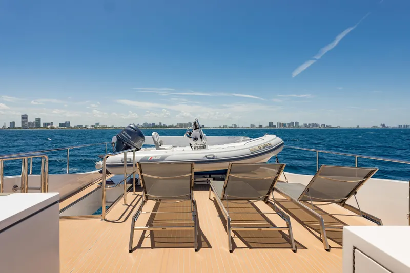 Slide: The Image of 2016 Hargrave Flybridge Motor Yacht deck with sun loungers and tender, ocean view. - 71