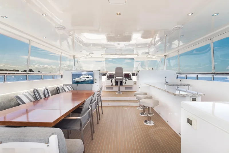 Slide: The Image of Luxurious 2016 Hargrave Flybridge Motor Yacht interior with dining area and panoramic ocean views. - 54