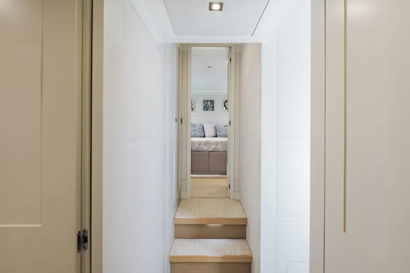 Slide: The Image of Hallway leading to a bedroom inside a 2016 Hargrave Flybridge Motor Yacht. - 24