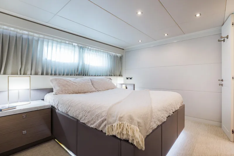 Slide: The Image of Luxurious bedroom interior on 2016 Hargrave Flybridge Motor Yacht, featuring elegant bedding and modern lighting. - 31