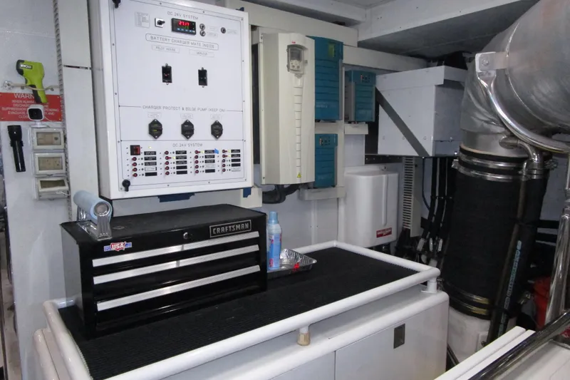 Slide: The Image of Engine room of 2016 Hargrave Flybridge Motor Yacht with control panels and tool chest. - 87