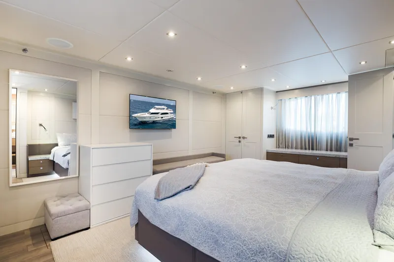 Slide: The Image of Luxurious bedroom with large bed, mirror, TV, and window with curtains. - 42