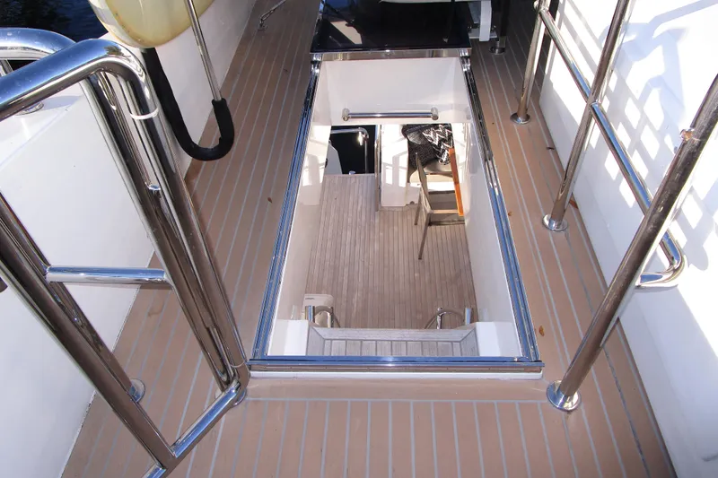 Slide: The Image of 2016 Hargrave Flybridge Motor Yacht deck with open hatch and stainless steel railings. - 72