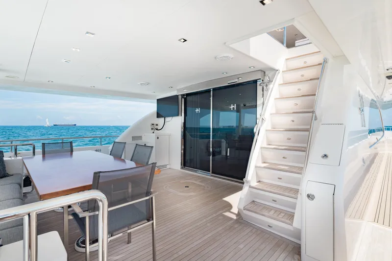 Slide: The Image of Luxurious 2016 Hargrave Flybridge Motor Yacht deck with ocean view and elegant seating. - 52