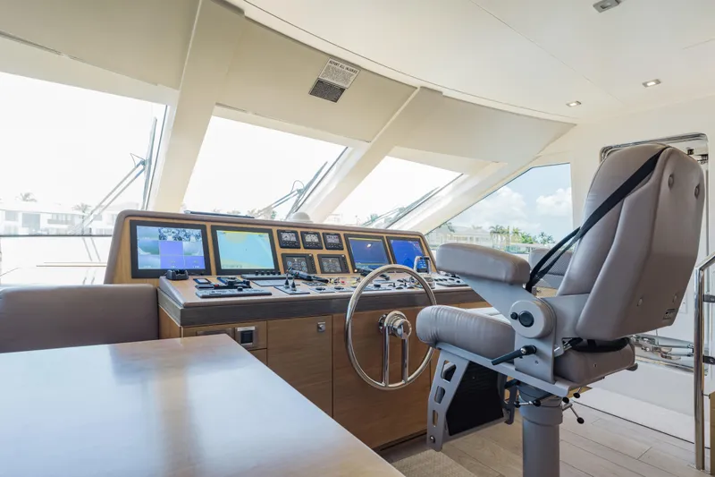 Slide: The Image of Helm station of 2016 Hargrave Flybridge Motor Yacht with navigation screens and captain's chair. - 16