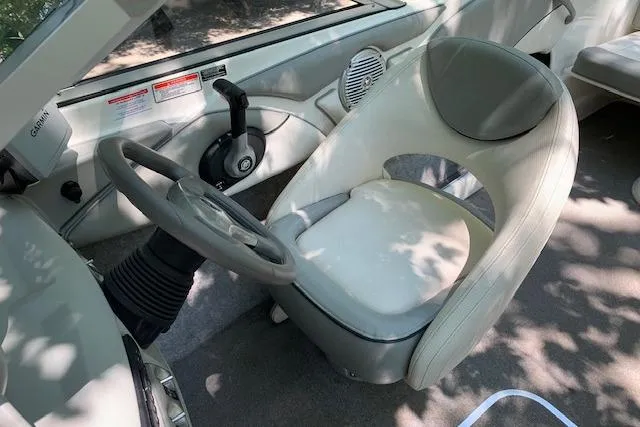 Slide: The Image of 2011 Bayliner 185 Bowrider interior with steering wheel and captain's chair. - 13