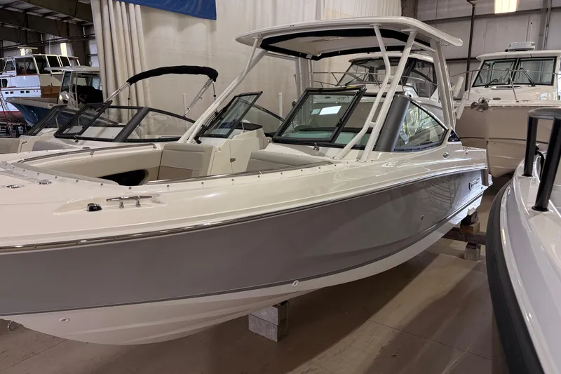 The Image of 2026 Boston Whaler 240 Vantage boat in showroom, showcasing sleek design and modern features. - 1
