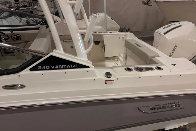 Slide: The Image of 2026 Boston Whaler 240 Vantage boat interior with seating and Mercury engine. - 2