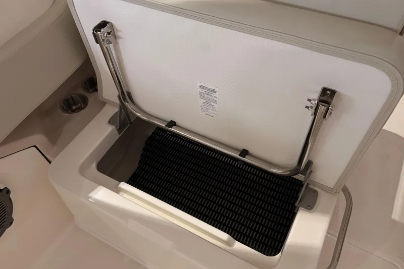 Slide: The Image of Open storage compartment on 2026 Boston Whaler 240 Vantage boat, showcasing interior design. - 11