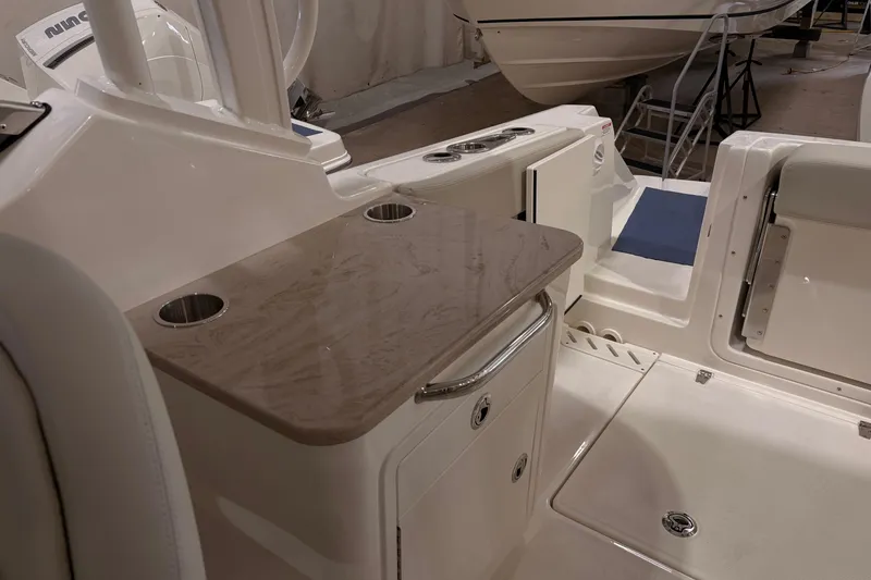 Slide: The Image of 2026 Boston Whaler 240 Vantage interior with table and seating area. - 7