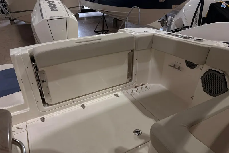 Slide: The Image of 2026 Boston Whaler 240 Vantage boat interior with seating and Mercury engine. - 8