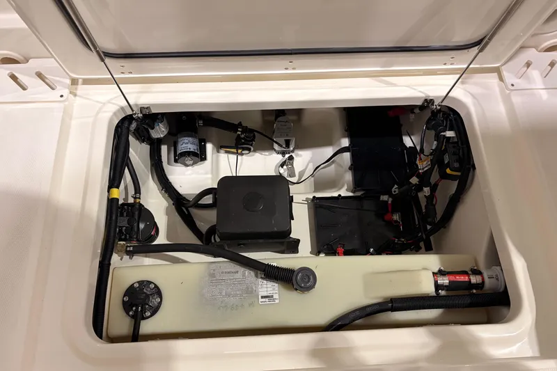 Slide: The Image of 2026 Boston Whaler 240 Vantage boat compartment with wiring and components. - 17