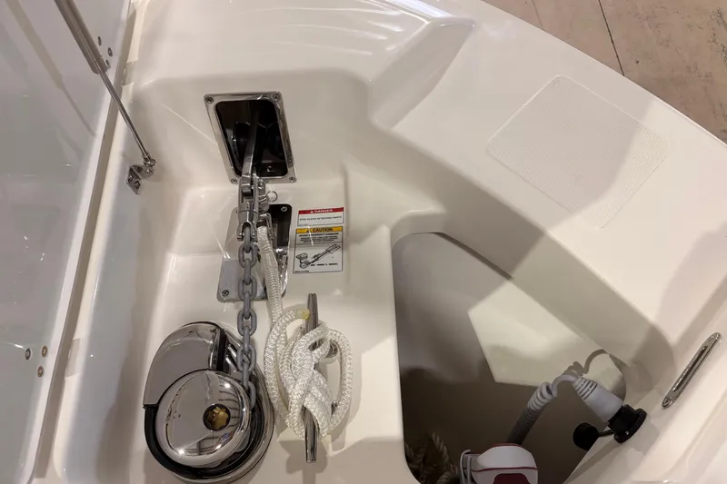 Slide: The Image of Anchor compartment of 2026 Boston Whaler 240 Vantage, featuring chain and rope storage. - 19