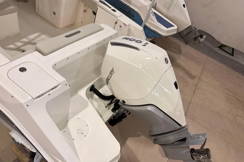 Slide: The Image of 2026 Boston Whaler 240 Vantage boat with Mercury outboard motor in showroom. - 6