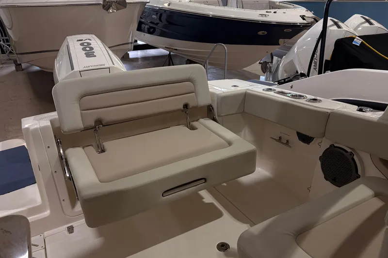 Slide: The Image of 2026 Boston Whaler 240 Vantage boat interior with seating and Mercury outboard engine. - 9