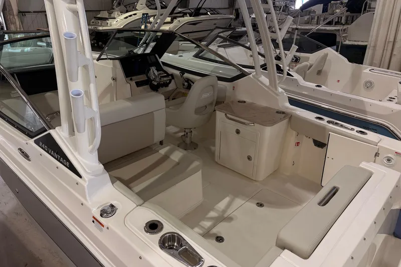Slide: The Image of 2026 Boston Whaler 240 Vantage boat interior with seating and helm in a showroom. - 4