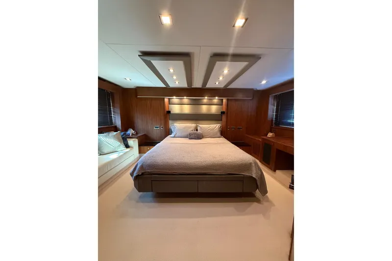 Slide: The Image of Luxurious bedroom interior of 2012 Sunseeker Predator Sport Yacht 74, featuring elegant wood paneling. - 23