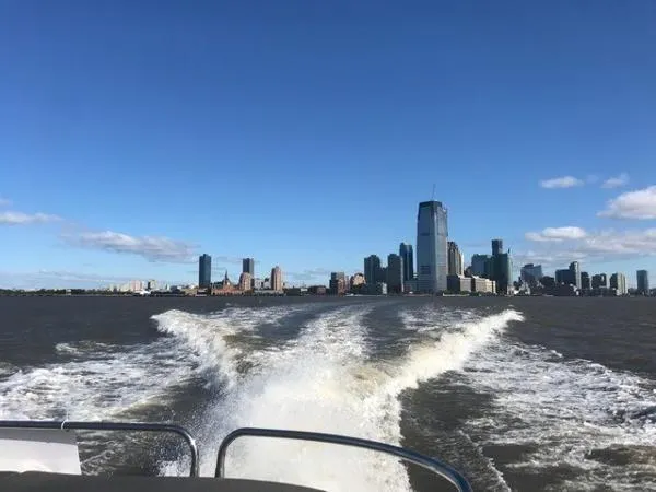 Slide: The Image of Sunseeker Predator Yacht 2012 cruising with city skyline view. - 31