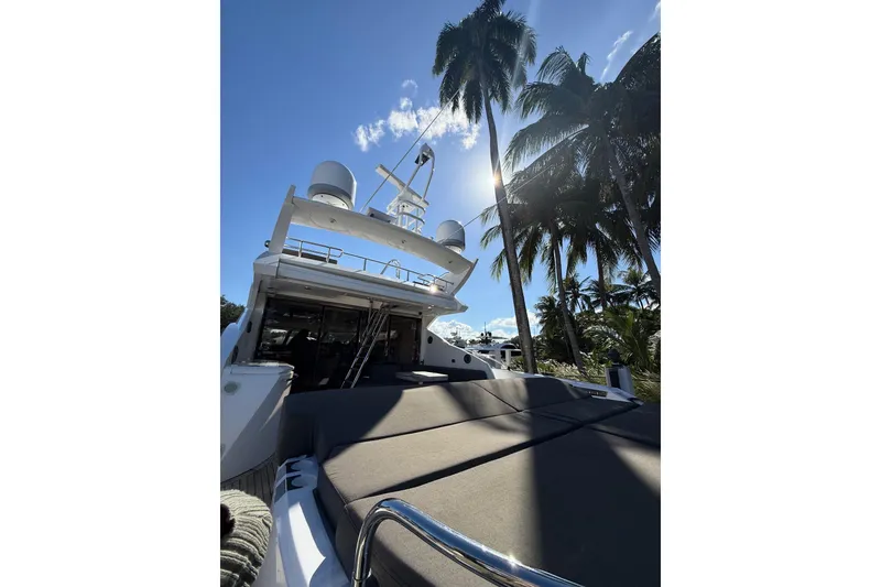 Slide: The Image of Sunseeker Predator Sport Yacht 74, 2012, under palm trees with clear blue sky. - 12