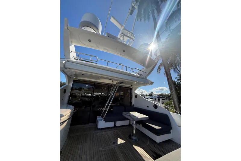Slide: The Image of 2012 Sunseeker Predator Sport Yacht 74, outdoor seating, sunny day, palm trees, luxury yacht. - 7
