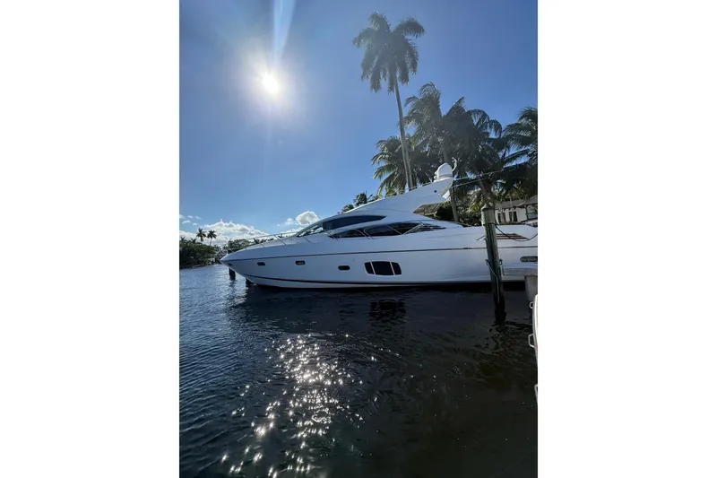 Slide: The Image of 2012 Sunseeker Predator Sport Yacht 74 docked under sunny skies with palm trees. - 35