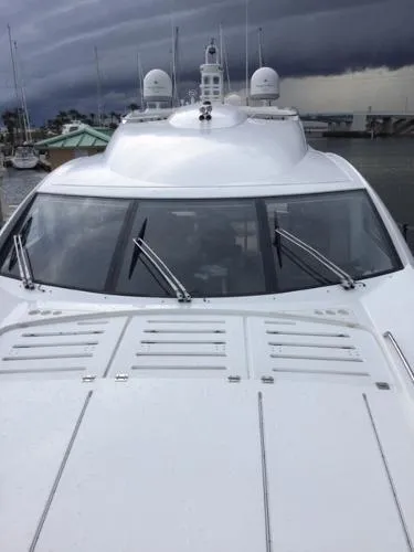 Slide: The Image of Sunseeker Predator Sport Yacht 74, 2012 model, docked under cloudy skies. - 4