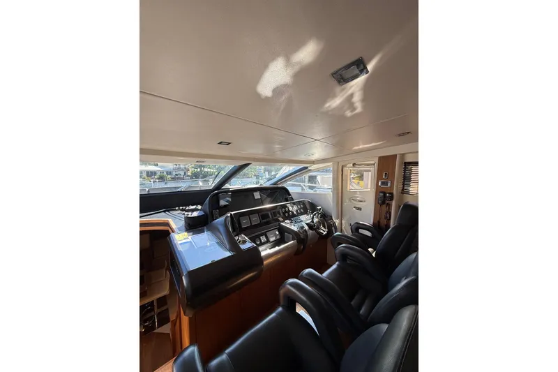 Slide: The Image of Interior cockpit of 2012 Sunseeker Predator Sport Yacht 74, featuring sleek controls and seating. - 20