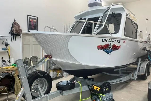 The Image of 2020 Hewescraft 240 Ocean Pro boat on trailer in garage setting. - 1